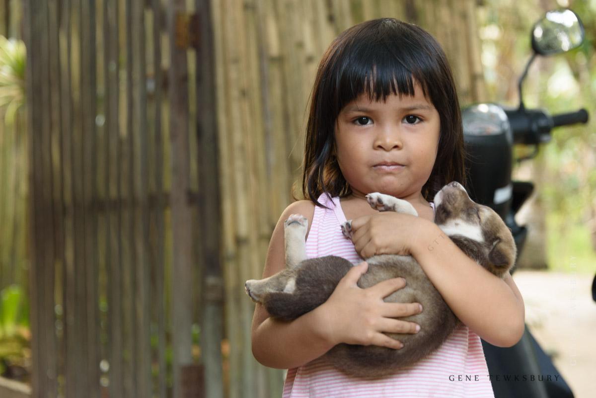 Philippines Photography Tours Filipina girl with dog in arms.